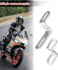 Motorcycle Exhaust Pipe Bracket 2 Pack Z Shape Stainless Steel Muffler Hanger Mount Clamp Universal Fit For Dirt Bikes Scooters Motocross Replacement Accessories Beefed Up Rugged Vibration Resistant displayed next to motorcycle