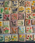 Colorful cookies with embossed floral designs using Spring Flowers Embossing Rolling Pin With 16 Floral Squares For Dough And Clay.