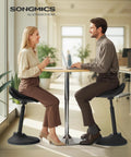 Two people using Ergonomic Wobble Stool With Height Adjustable Desk Seat For Standing Use, Swivel Balance Chair, Ink Black in an office
