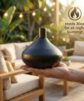Person holding citronella tabletop torch candles for outdoor patio and deck, 30oz stainless steel mosquito repellent torches in black finish
