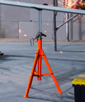 Front view of orange steel pipe stand with adjustable threaded center and V-head on tripod base