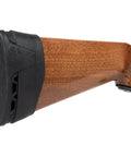 Recoil Eraser II Slip-On Pad for Medium Firearms on a wooden rifle stock, comfortable black cushion for rifles and semi-auto shotguns.
