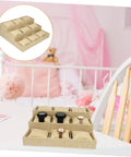 Multi Grid Watch Organizer Tray With Linen Padded Sections perfect jewelry display stand for rings and bracelets on a table.
