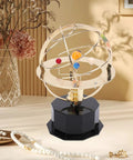 Gold Tone Solar System Model Decoration with iron and plastic orrery on desk with decorative background