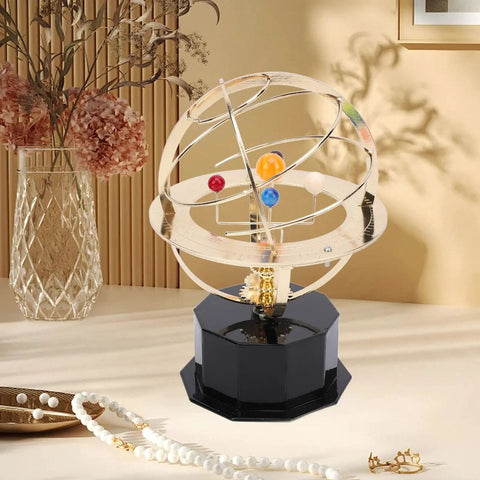 Gold Tone Solar System Model Decoration with iron and plastic orrery on desk with decorative background