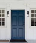 Built Different Matte Black Outdoor Wall Lights With Dusk To Dawn Motion Sensor And Water Glass Shade on blue door entrance.