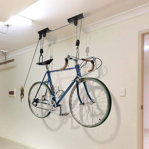 Ceiling Mount Bike Hoist Set Of 2 With Pulley System And Bike Hangers Easy Overhead Storage For Garage Or Workshop Holds Up To 55 Lbs Each Heavy Duty Rope Smooth Operation Space Saving mounted on ceiling holding a road bike