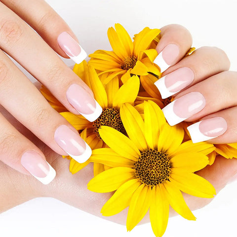 French manicured nails holding yellow flowers, prepared with Mini Nail Buffer Blocks Set 100 180 Grit For Nail Prep And Gel Polish Sponge Buffing Sanding Blocks File Kit Pro Grade Bulk 50 Pcs Pink For Home And Salon Manicures Nail Art Prep Smooth Finish