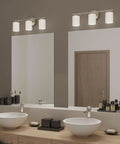 Three Light Etched White Glass Modern Bath Vanity Light With Brushed Nickel Finish in bathroom setting