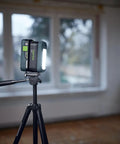 Go Anywhere Cordless Task Light SYSLITE KAL C illuminating a room from a tripod, showcasing its bright, even light for tight spaces.