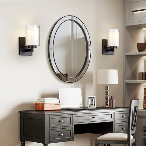 Pair Of Farmhouse Style Oil Rubbed Bronze Wall Sconces With Seeded Glass Shades beside mirror above desk in living room