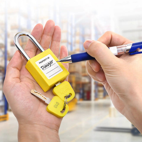 Person holding yellow padlock from 10 Pack Lockout Tagout Locks With Unique Keys Per Lock Yellow Padlocks For Lockout Tagout Stations And Devices Durable Industrial Grade OSHA Compliant Keyed Different 2 Keys Per Lock with attached keys.