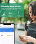Woman checking Gen2 Smart Soil Moisture Sensor data on smartphone app, showcasing remote monitoring with Zigbee hub integration.