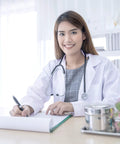 Female doctor wearing White Lab Coat For Women With Long Sleeves, 1 Pack, Small Size, sitting at desk with pen