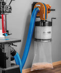 Heavy Duty Wall Mount Dust Collector Generating 650 Cfm Airflow With Precision One Micron Canister Filter mounted beside a bandsaw.