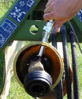 Using Grease Gun Coupler XL Universal Fit With 3.5 Inch Extra Reach For Recessed Fittings on machinery part in field