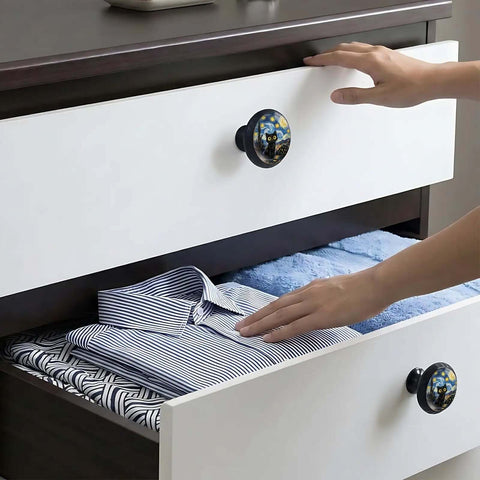 Four Pack Starry Sky Black Cat Cabinet Knobs on white drawer with hand opening it