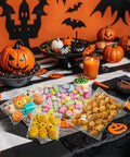 Clear 4x4 Inch Resealable Cookie Bags, 200 Pack, on Halloween table with cookies and candy, pumpkins and decorations in background