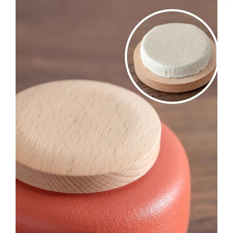 Close-up of snug wooden lid on a top shelf ceramic tea canister from the set of 4, featuring durable porcelain jars.