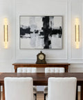 Natural Alabaster Wall Sconces Set Of Two Cylinder LED Wall Lights With Matte Black Metal Base illuminating a modern dining room.