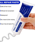 Hand holding a tube of wall repair paste for drywall repair kit with putty and plaster tape and patches for quick crack and nail hole fixes.