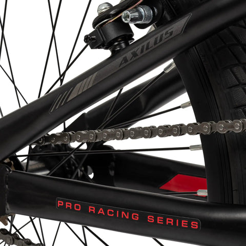 Close-up of Axilus Kids BMX Bike For Intermediate Riders with 20 Inch Wheels showing chain and Pro Racing Series detail.