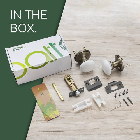 Porcelain White Door Knobs With Privacy Lock For Interior Doors box contents and hardware displayed on wooden surface.