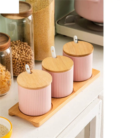 Top Shelf Ceramic Coffee Storage Jar With Secure Wooden Lid And Airtight Design Keeps Daily Grind Sugar Salt Tea Fresh As Ever While Looking Slick On Any Modern Counter Space. Pink jars with wooden lids on bamboo tray.