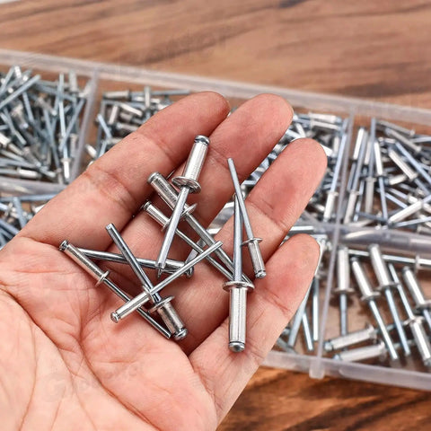 Hand holding aluminum rivets from 500 Piece Aluminum Blind Rivet Kit With 14 Size Assortment Pop Rivets Set For DIY Auto Marine