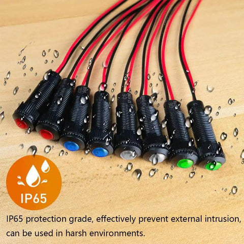 Eight Piece LED Indicator Pilot Lights Set Red Blue Green White For Panel Mount 8mm Hole AC DC 12 24V on wooden surface.