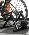 Indoor Bike Trainer With Magnetic Resistance Foldable Portable Turbo Trainer Stand For 24 To 28 Inch Mountain Bikes And 700C Road Bikes Easy Setup Durable Steel Frame For A Solid Home Gym Ride used in a home setting.