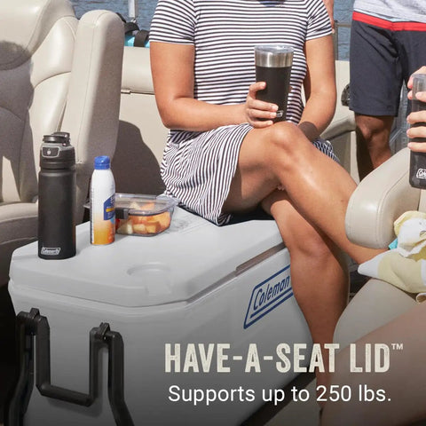 Person sitting on boat using 100 Qt Wheeled Marine Cooler With Fully Insulated Lid And Body Keeps Ice Up To Five Days In 90 Degree Heat Holds 160 Cans UV Coated Exterior And Rust Resistant Stainless Hardware Built Tough For Weekend Adventures as a seat