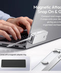 Hands connecting a Heavy Hitting M2 NVMe Enclosure Delivering Legit 80Gbps USB4 Speeds to a laptop for portable storage.