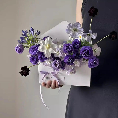 Five Pack Envelope Style Gift Boxes For Flowers And Crafting Parties with purple and white flowers, held by a person.