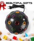 Spinning 11 Inch Disco Ball With LED Lights And 360 Degree Rotation for parties, surrounded by toys, plug visible