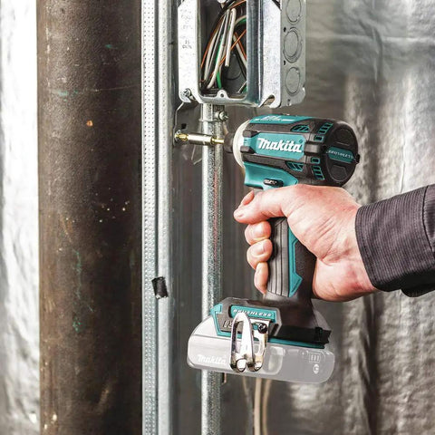 Hand holding XDT16Z 18V LXT Brushless Cordless Impact Driver With Quick Shift Mode, fastening metal frame indoors.