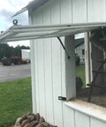 Six Pack 100N Gas Struts for 10 Inch Cabinet Doors Cabinet Shocks and Lift Supports with Round Mounting Plates visible installed on exterior shed window for smooth lifting