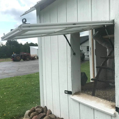 Six Pack 100N Gas Struts for 10 Inch Cabinet Doors Cabinet Shocks and Lift Supports with Round Mounting Plates visible installed on exterior shed window for smooth lifting