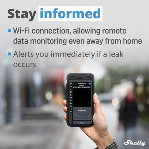 Hand holding phone displaying app for Wireless Flood Sensor With Temperature Measurement For Home Automation in urban setting