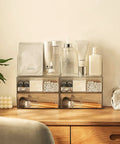 Two Tier Drawer Organizer For Medicine Cabinet Stackable Clear Storage Drawers For Small Bathroom Vanity Cabinet Mirror Or Wall Mount Keeps Essentials Neat And Visible on a wooden shelf with makeup and skincare items above.