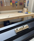 M6 X 1.0 T Slot Nut With Spring Ball Loaded, 10 Pack, Carbon Steel, installed on 8mm aluminum extrusion rail in workshop setting