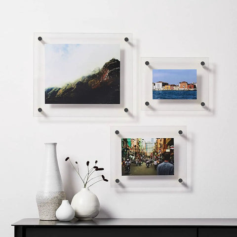 Top Tier Eight Pack Standoff Mounts Three Quarter By One Inch Brushed Stainless Steel Wall Brackets holding three photos.
