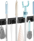 Wall Mount Mop And Broom Holder With Four Slots And Four Hooks For Quick Easy Gear Organization In Pantry Closet And Laundry Room Heavy Duty Black Rustic Wood Tool Organizer For Indoor Or Outdoor Use displaying various tools.