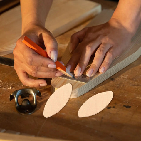 Pro Grade Hardwood Biscuit Joiner Kit With Precision Slotting Jigs And Matched Wooden Dowels For Rock Solid Plywood Connections Slick No Sweat Assembly Today. Hands marking wooden dowels on plywood surface.