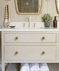 Bathroom vanity with Antique Brass Cabinet Knob Set 6 Pack Solid Zinc Alloy Drawer Pulls on white drawers