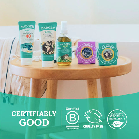 Wooden table displaying Organic Baby Oil With 5 Simple Ingredients To Soften Dry Skin And Cradle Cap, Kid Safe And Mom Approved.