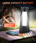 Rechargeable Camping Light With Stand Cordless Work Light With Three Led Heads And 5500 Lumens Dimmable Brightness 15000mAh Battery For Up To 25 Hours Runtime Detachable 86 Inch Tripod Emergency Outdoor Flashlight For Camping on table with smartphone charging.