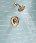 Linden 14 Series Shower Trim Kit With 5 Spray Touch Clean Shower Head in Venetian Bronze installed on blue tiled wall.