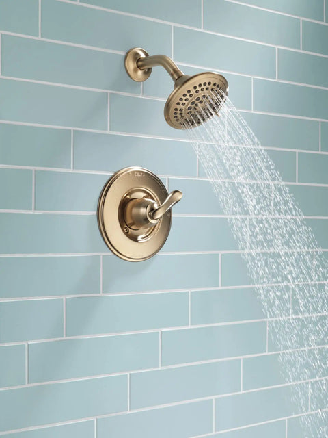 Linden 14 Series Shower Trim Kit With 5 Spray Touch Clean Shower Head in Venetian Bronze installed on blue tiled wall.