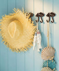 Straight Up Legit Mushroom Wall Hooks Set Of Two Heavy Duty Cast Iron Coat Hangers With Antique Black Finish holding a straw hat and decor.